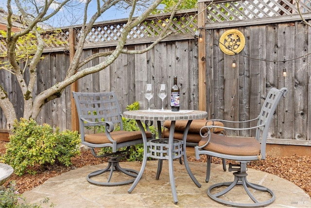 view of patio / terrace featuring fence