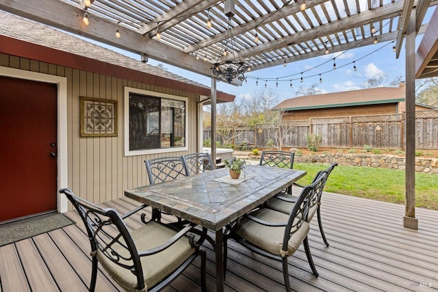 wooden deck featuring a yard, outdoor dining space, fence, and a pergola