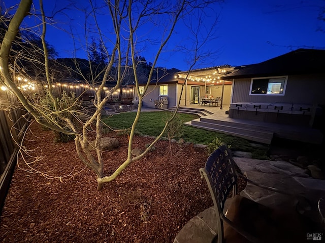 view of yard at twilight