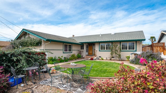 exterior space featuring a yard, a patio, fence, and stucco siding