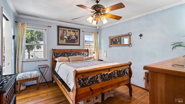 bedroom featuring ornamental molding, light wood-type flooring, and baseboards