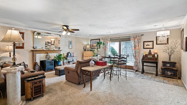 living area with a wood stove, stone tile flooring, a textured ceiling, crown molding, and ceiling fan with notable chandelier