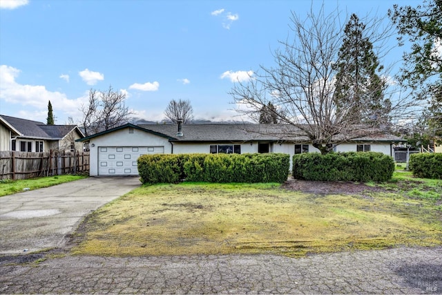 ranch-style home with a garage, driveway, fence, and stucco siding