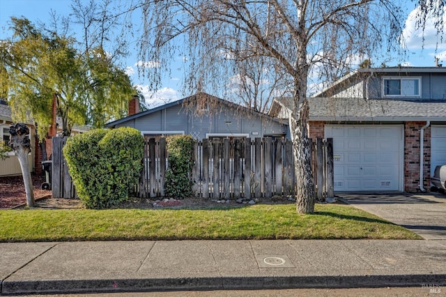 view of front of house featuring brick siding, a chimney, fence, a garage, and driveway