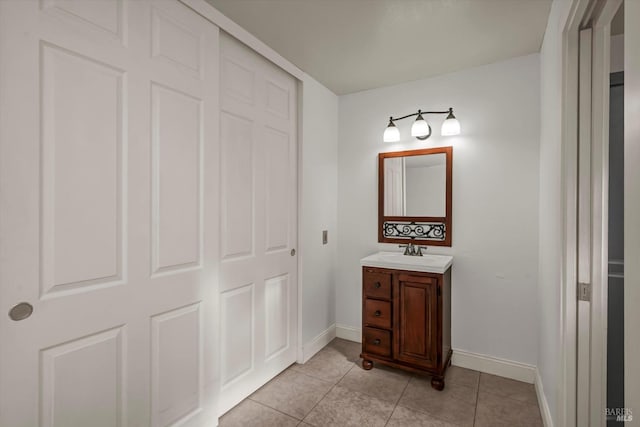 bathroom featuring baseboards, vanity, and tile patterned floors