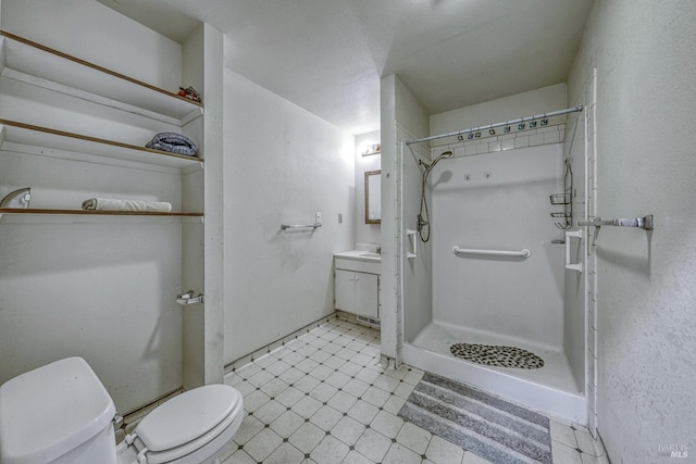 full bath with a stall shower, vanity, toilet, and tile patterned floors