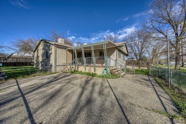 view of front of home with fence and a porch