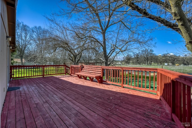 wooden terrace featuring fence