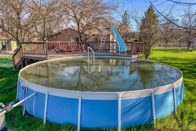 view of pool featuring a yard and a wooden deck