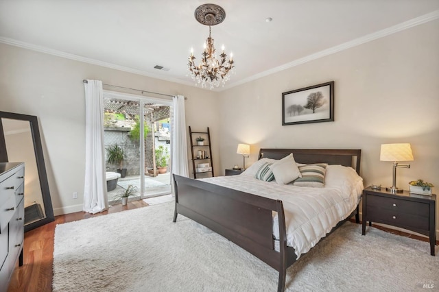 bedroom featuring visible vents, ornamental molding, wood finished floors, access to exterior, and a chandelier