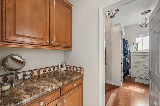 interior space with an inviting chandelier, wood finished floors, and vanity