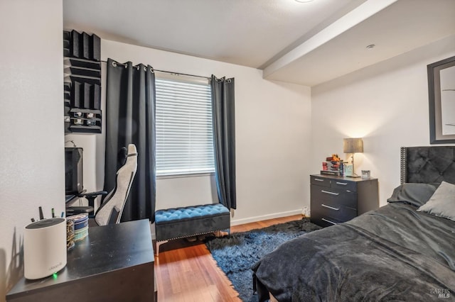 bedroom featuring dark wood finished floors and baseboards