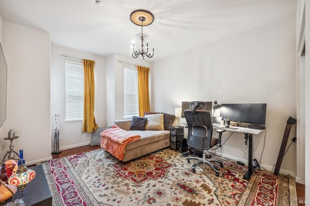 home office with a notable chandelier, baseboards, and wood finished floors