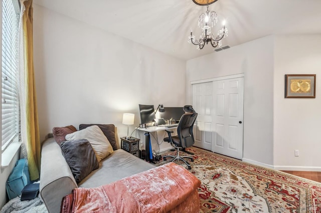 office featuring baseboards, visible vents, and a chandelier