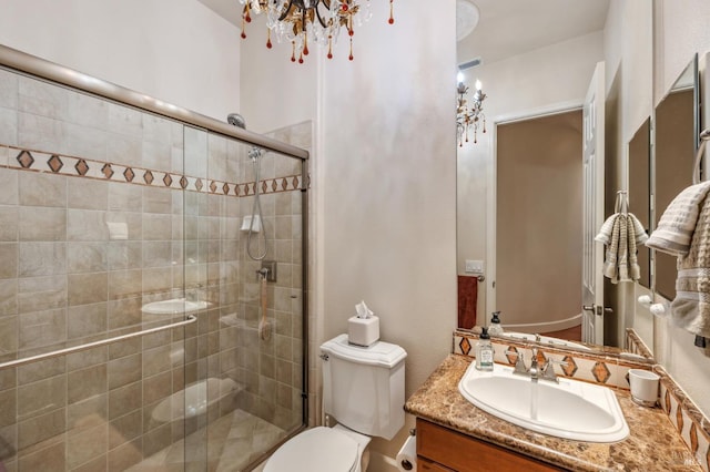 bathroom featuring toilet, a shower stall, visible vents, and vanity