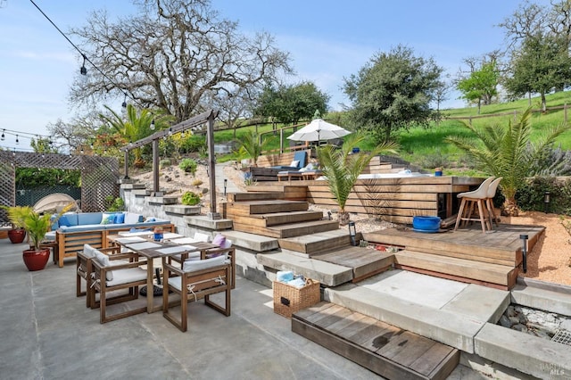 view of patio / terrace with a deck, outdoor dining area, and an outdoor living space