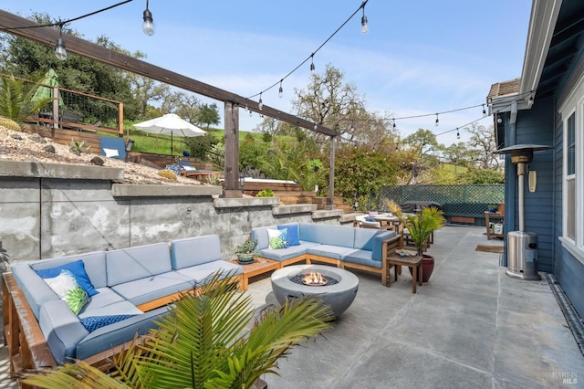 view of patio / terrace featuring an outdoor living space with a fire pit