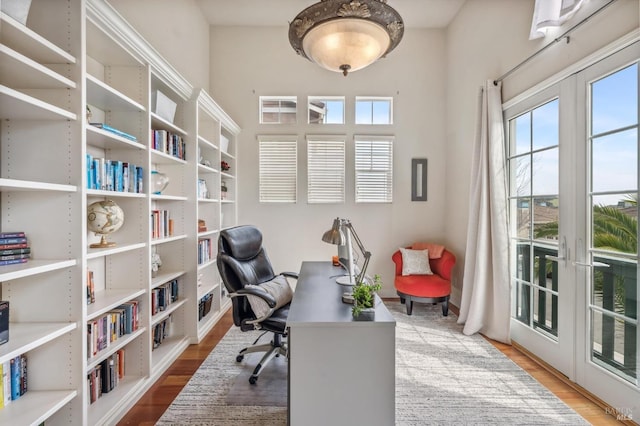 office with french doors and wood finished floors