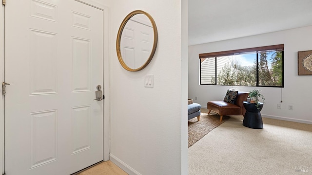 foyer with light carpet and baseboards