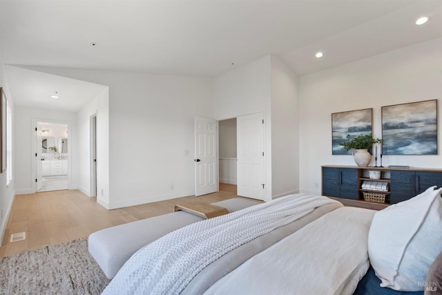 bedroom with baseboards, light wood finished floors, connected bathroom, and recessed lighting