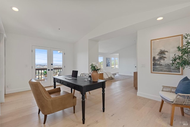 office with vaulted ceiling, french doors, baseboards, and light wood-style floors