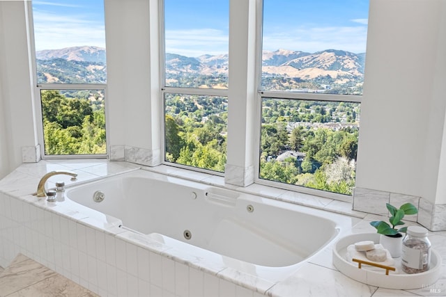 bathroom with a whirlpool tub and a mountain view