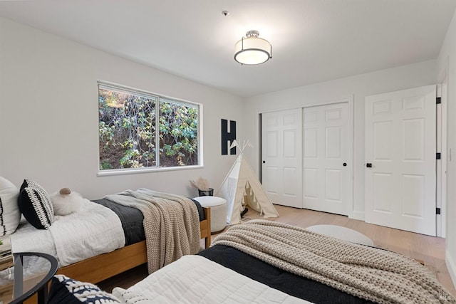 bedroom featuring light wood-type flooring and a closet