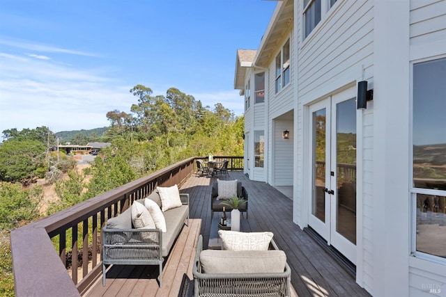 wooden deck with french doors and an outdoor hangout area