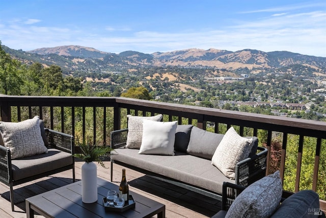 deck with outdoor lounge area and a mountain view