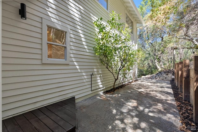 view of side of property featuring fence