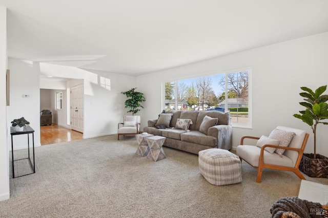 carpeted living room featuring baseboards