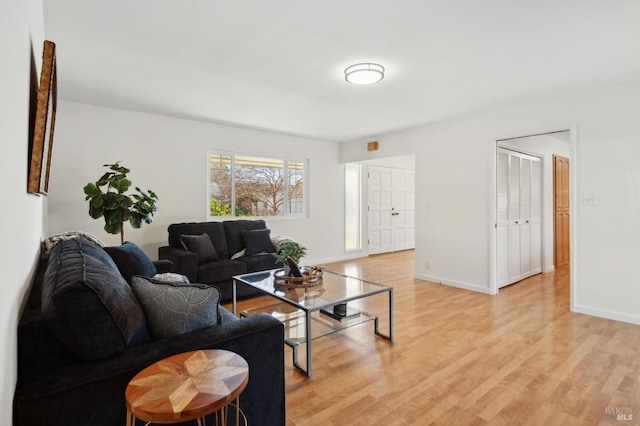 living area with light wood finished floors and baseboards