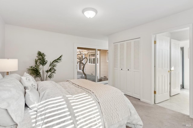 bedroom with a closet and light colored carpet