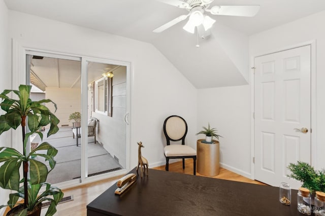 living area with light wood-style floors, ceiling fan, baseboards, and vaulted ceiling