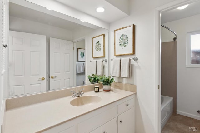 full bath with tile patterned floors, baseboards, shower / washtub combination, and vanity