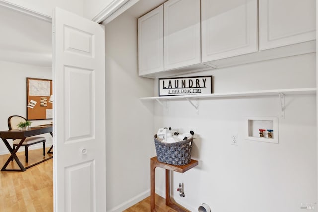 laundry area with light wood finished floors, washer hookup, cabinet space, and baseboards