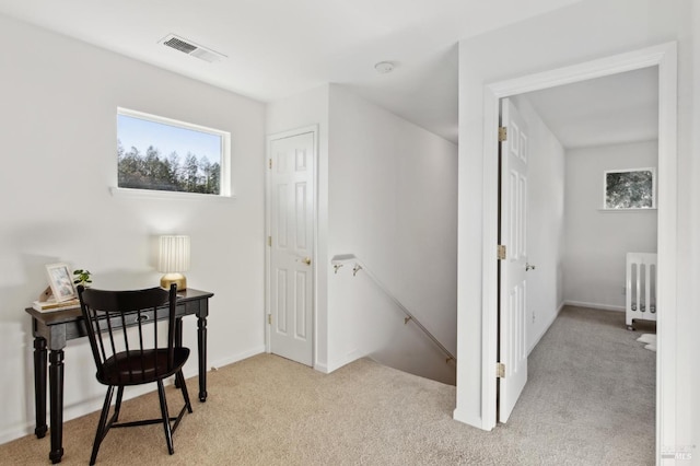 carpeted office featuring baseboards, visible vents, plenty of natural light, and radiator heating unit