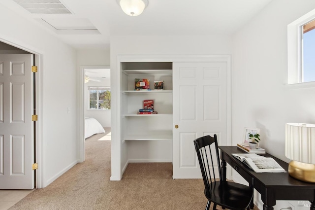 office space featuring light carpet, visible vents, and baseboards