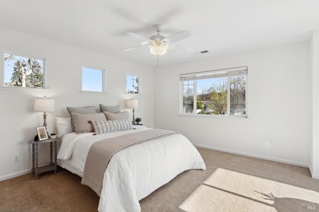 bedroom featuring a ceiling fan, carpet, visible vents, and baseboards