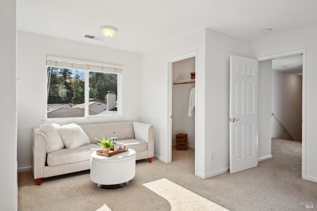 sitting room featuring carpet, visible vents, and baseboards