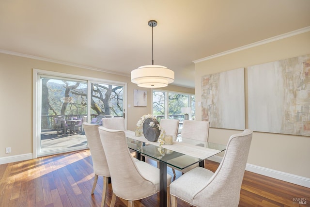 dining area with ornamental molding, hardwood / wood-style flooring, and baseboards