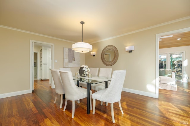 dining area featuring baseboards, wood finished floors, and ornamental molding