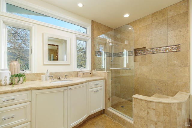 full bathroom with a shower stall, vanity, and recessed lighting