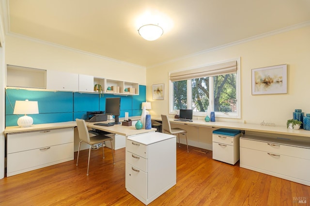 home office featuring light wood-type flooring and crown molding