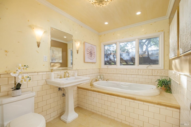 full bath featuring toilet, a wainscoted wall, a garden tub, tile patterned flooring, and crown molding