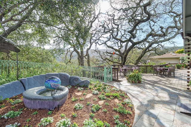 view of yard with outdoor dining area and fence