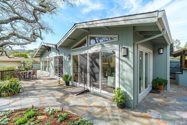 back of house featuring outdoor dining area and a patio area