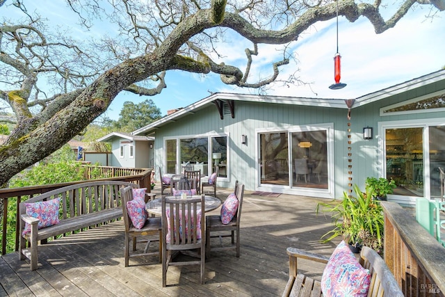 wooden terrace featuring outdoor dining area