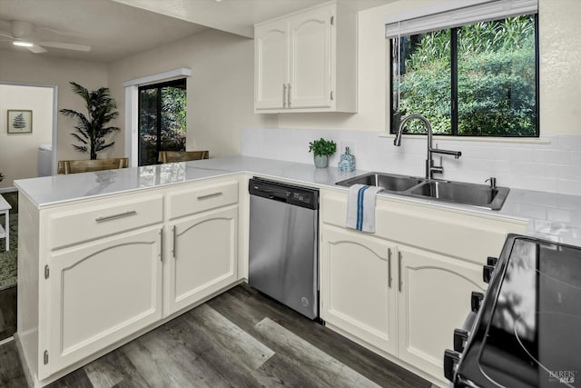 kitchen featuring dark wood-style floors, a peninsula, black / electric stove, stainless steel dishwasher, and a sink