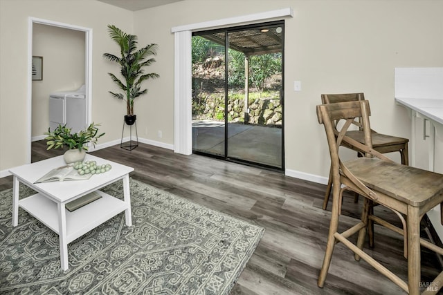 sitting room featuring independent washer and dryer, wood finished floors, and baseboards